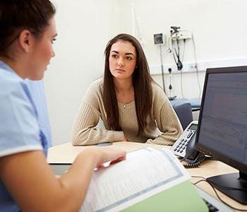 Student talking with medical provider in a clinic setting